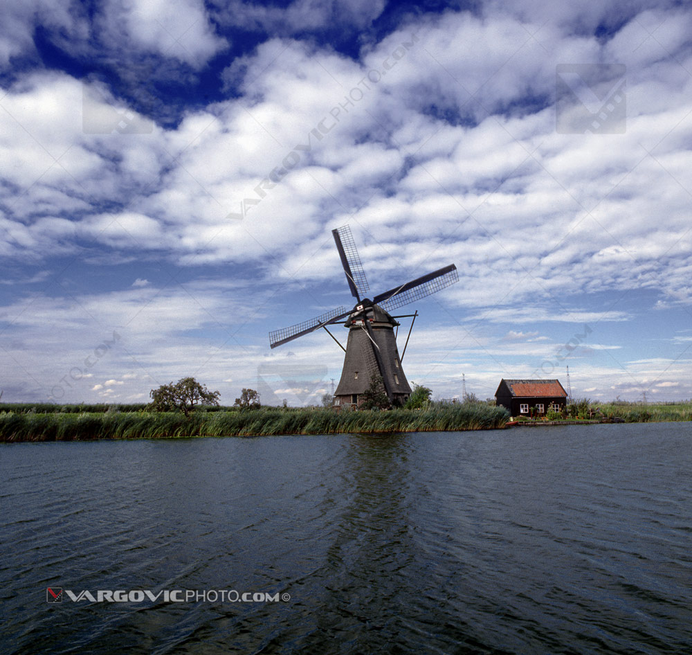 Cloudy summer day in Kinderdijk in the land of windmills, Holland by art photographer Boris Vargovic